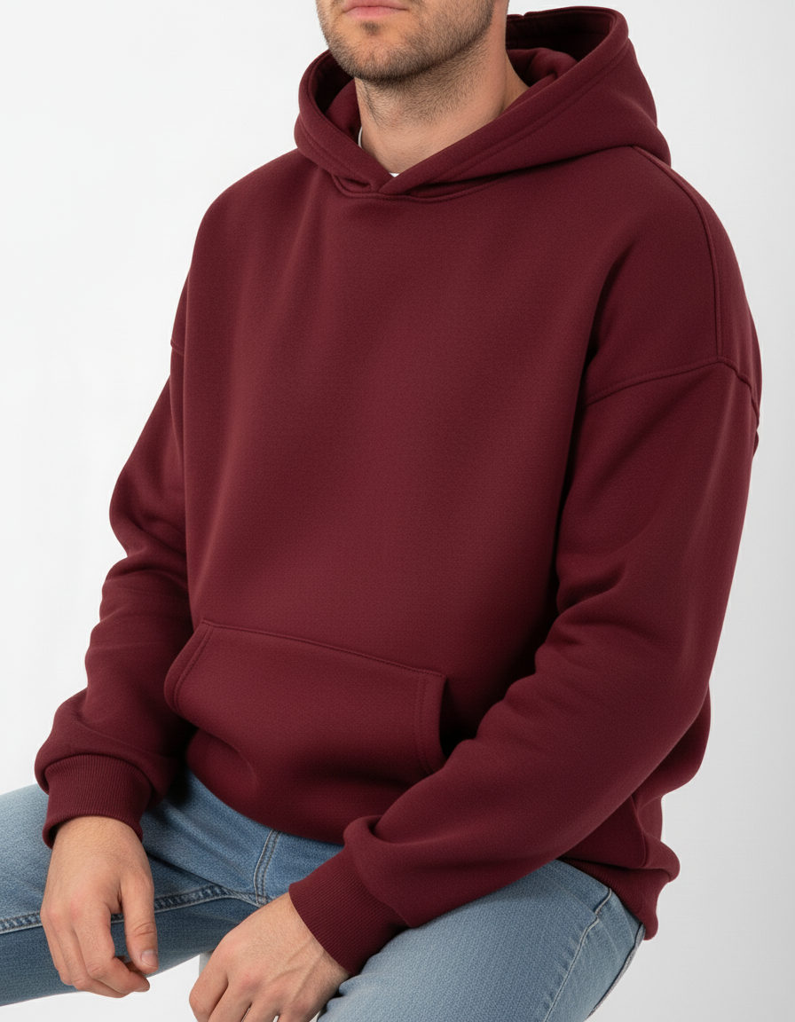 Person wearing a maroon hoodie on a white background
