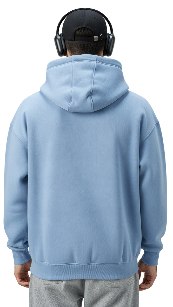 Person wearing a light blue hoodie and gray pants on a plain background