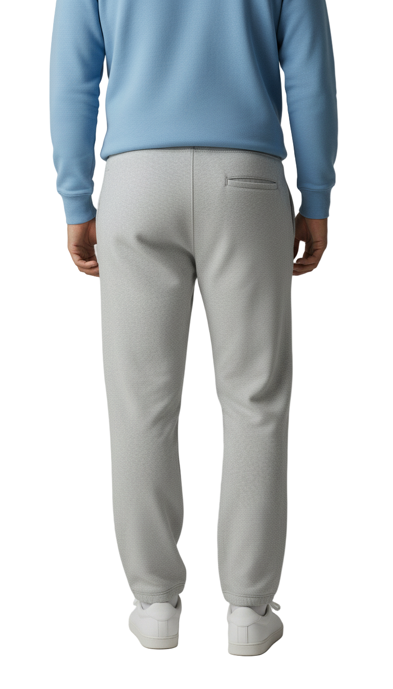 Person wearing a light blue sweater and gray pants on a plain background