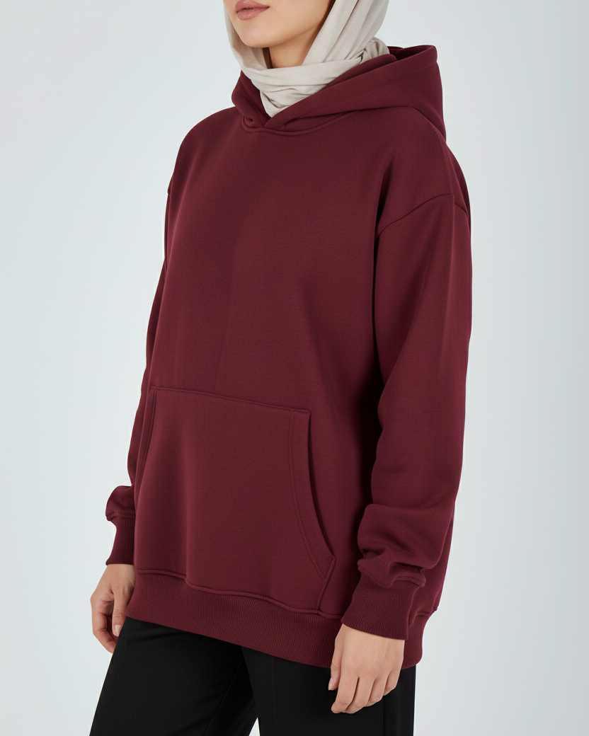 Maroon hoodie worn by a person on a white background