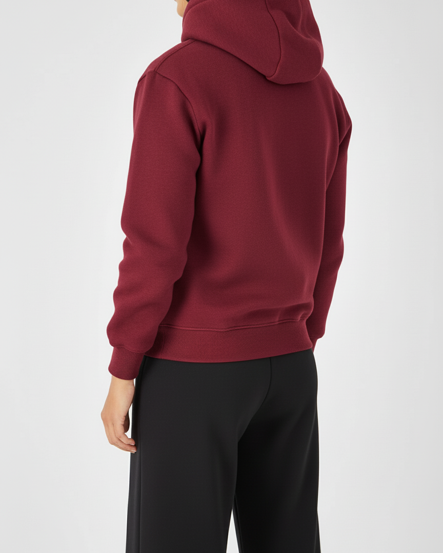 Person wearing a red hoodie and black pants on a white background