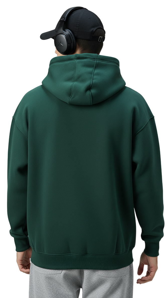 Person wearing a green hoodie and gray pants on a plain background