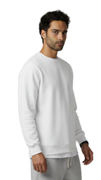 Man wearing a white sweatshirt and gray pants on a light gray background