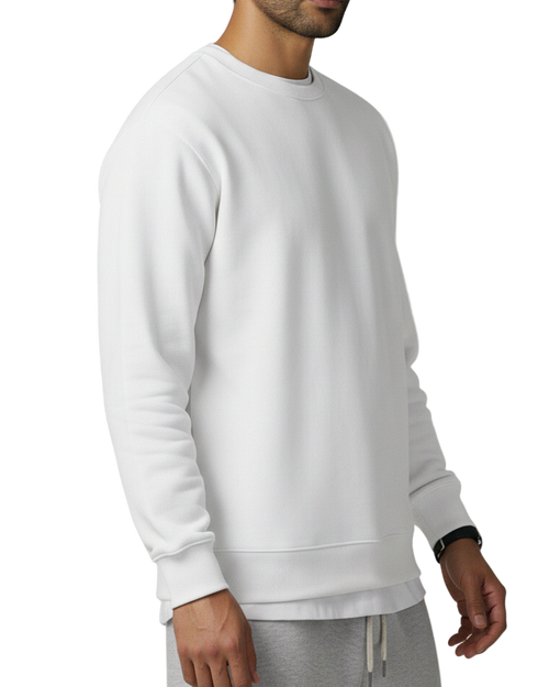 Man wearing a white sweatshirt and gray pants on a light gray background