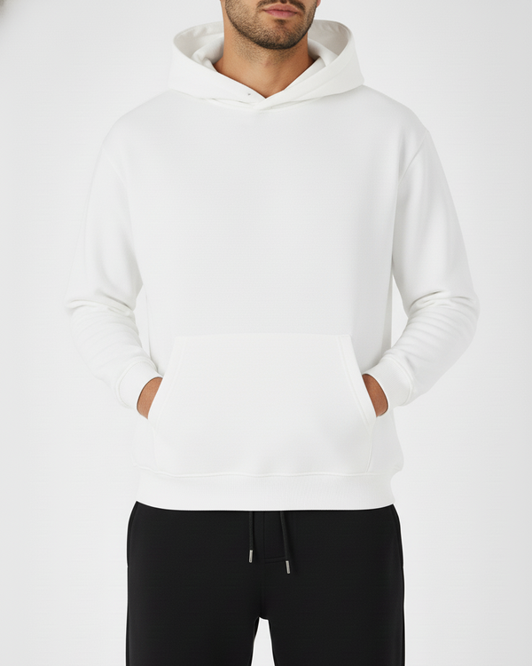 Person wearing a white hoodie and black pants on a white background