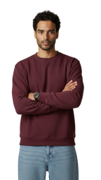 Man wearing a maroon sweatshirt and light blue jeans against a plain background
