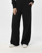 Woman wearing a black outfit on a white background