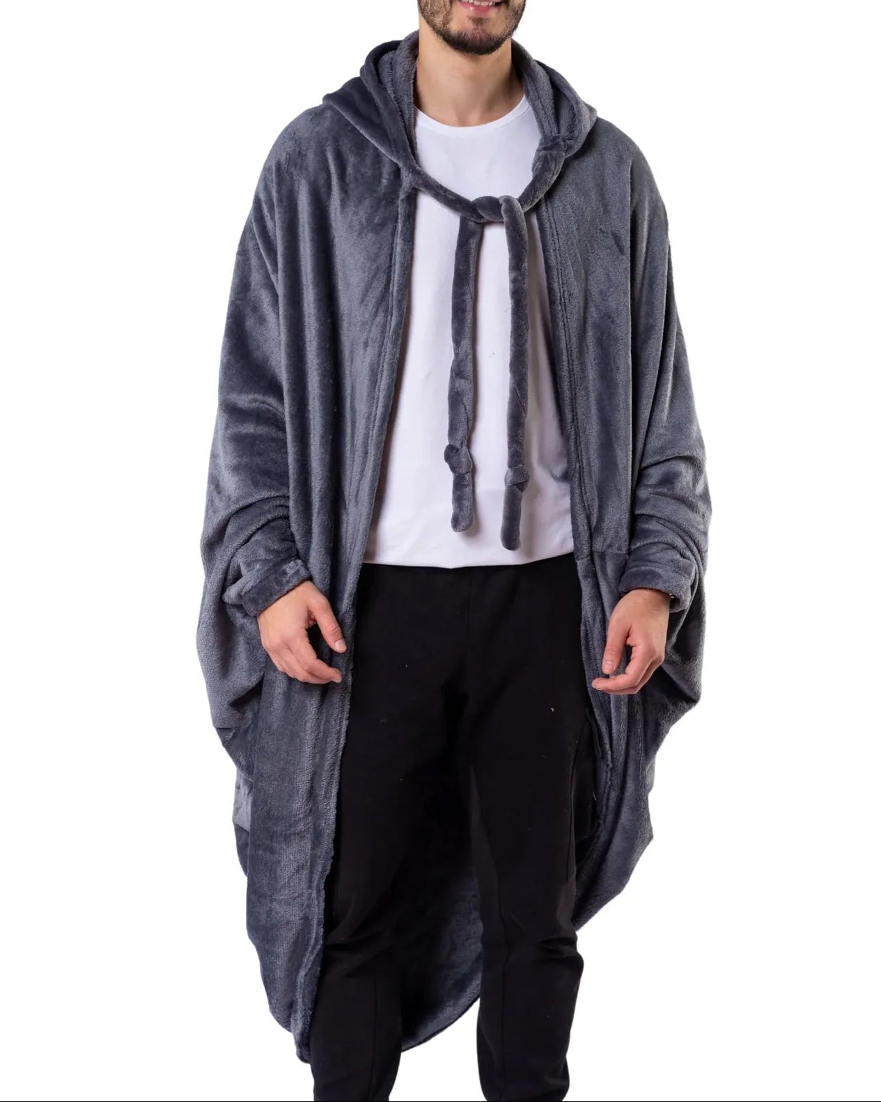 Man wearing a long gray hoodie over a white shirt and black pants on a white background